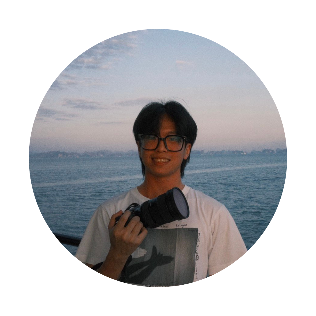 Favian Cheong holding a camera by the sea